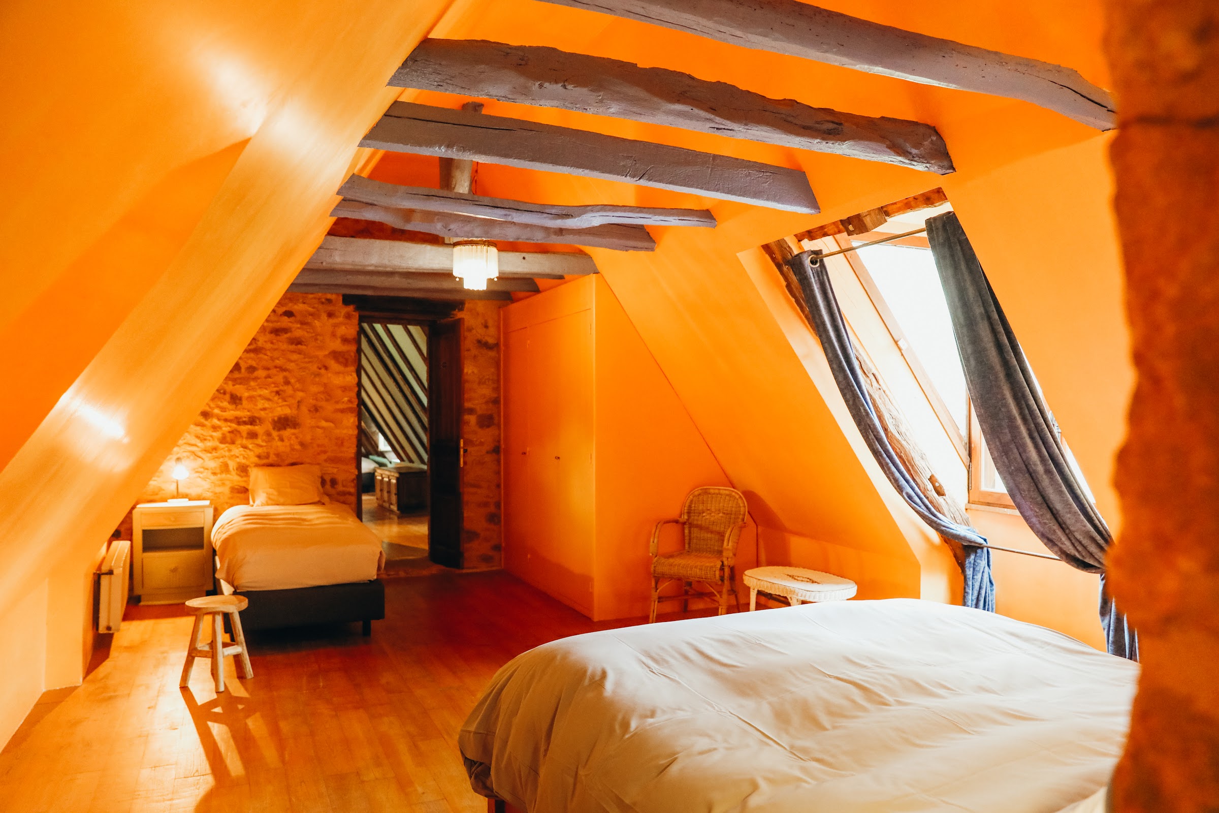 Chambre aux murs de pierre et poutres